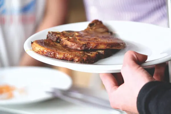 Glazed beef short ribs served on a white plate