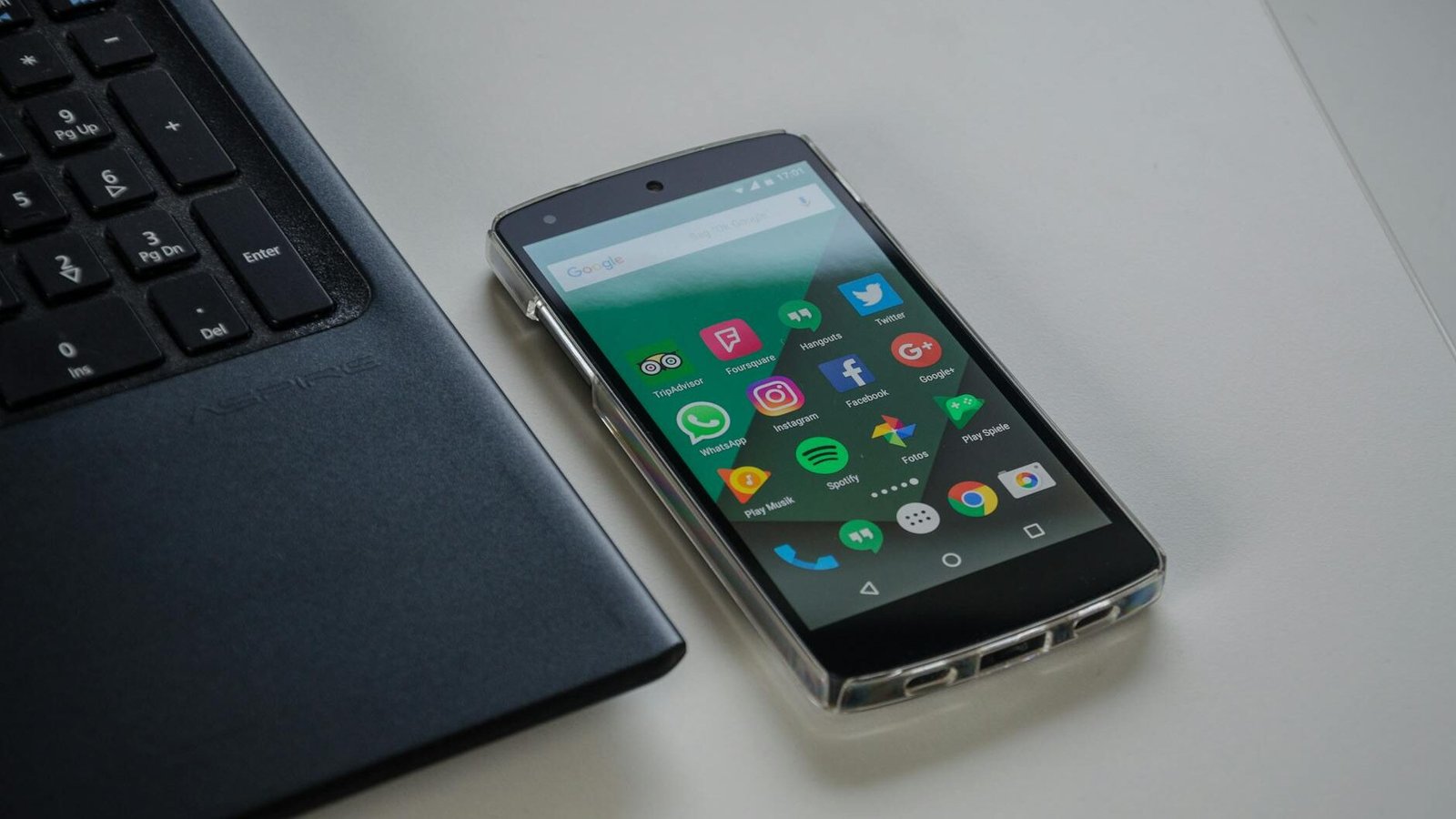black android smartphone near laptop